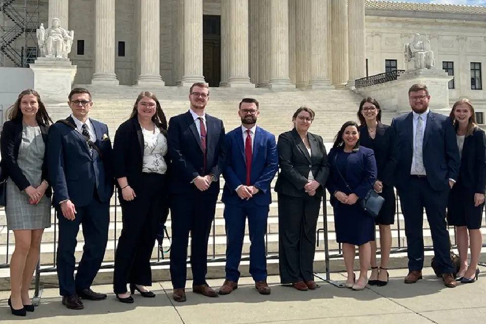 WVU Law students standing in front of a monument on Capital Hill in D.C.