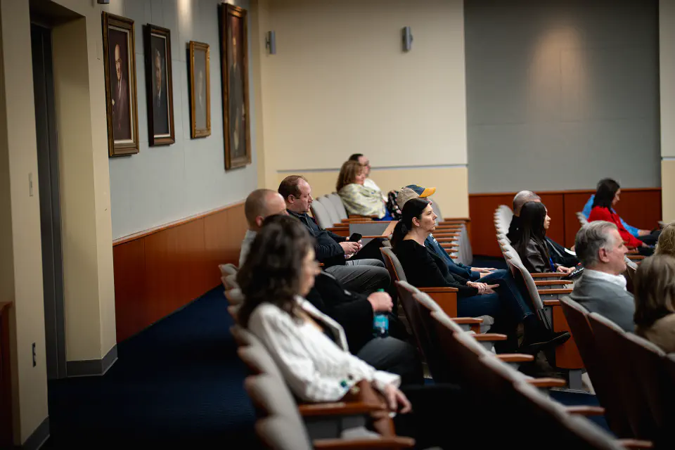 WVU Law faculty sit in seats in their large auditorium.