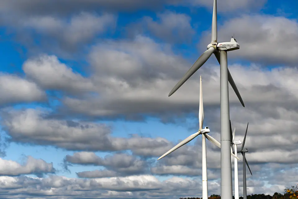 Three solar windmills and a cloudy sky.