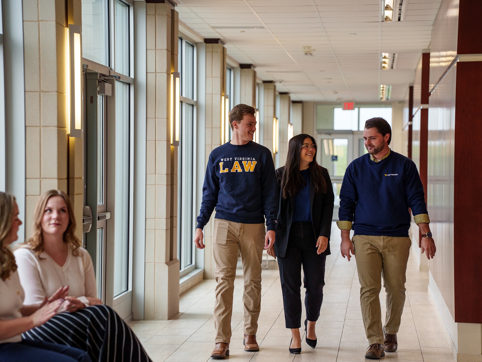 WVU Law students walk through a hallway together.