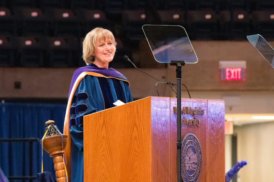 Photo of Senior Justice Beth Walker standing at the commencement podium.