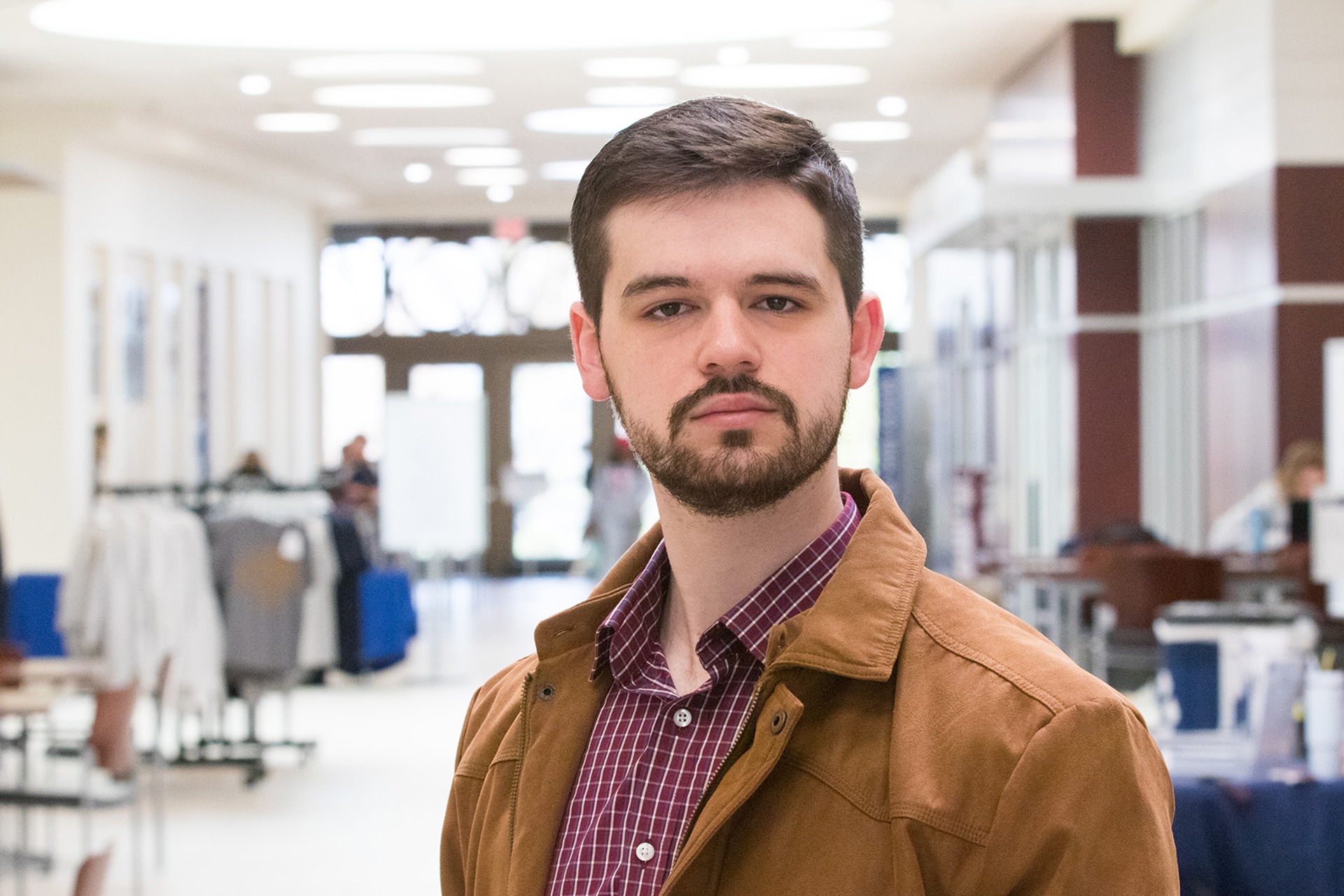 Photo of WVU Law student Grant Joynes standing in the law school atrium.