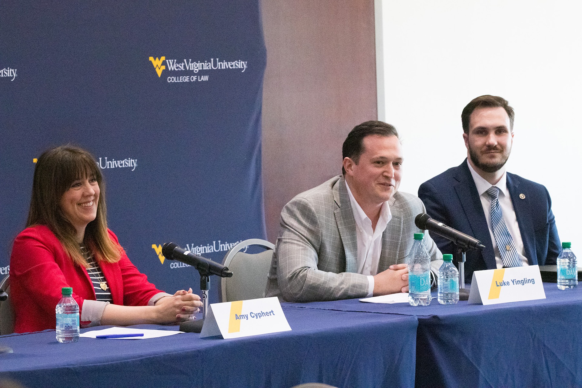 Three people, including Amy Cyphert and Luke Yingling, sit at a table panel at the Law Review Symposium.