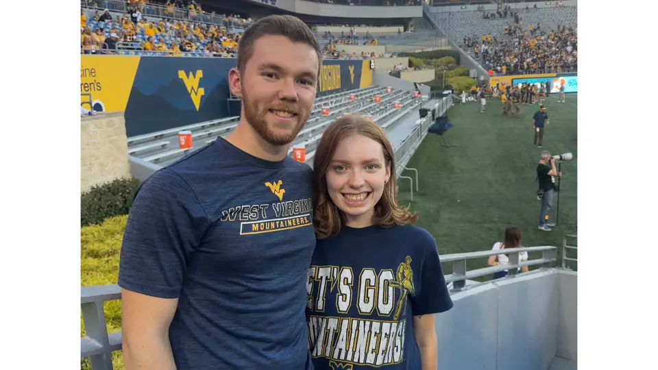 Parker and Kayla pose together at a Mountaineer Football game.