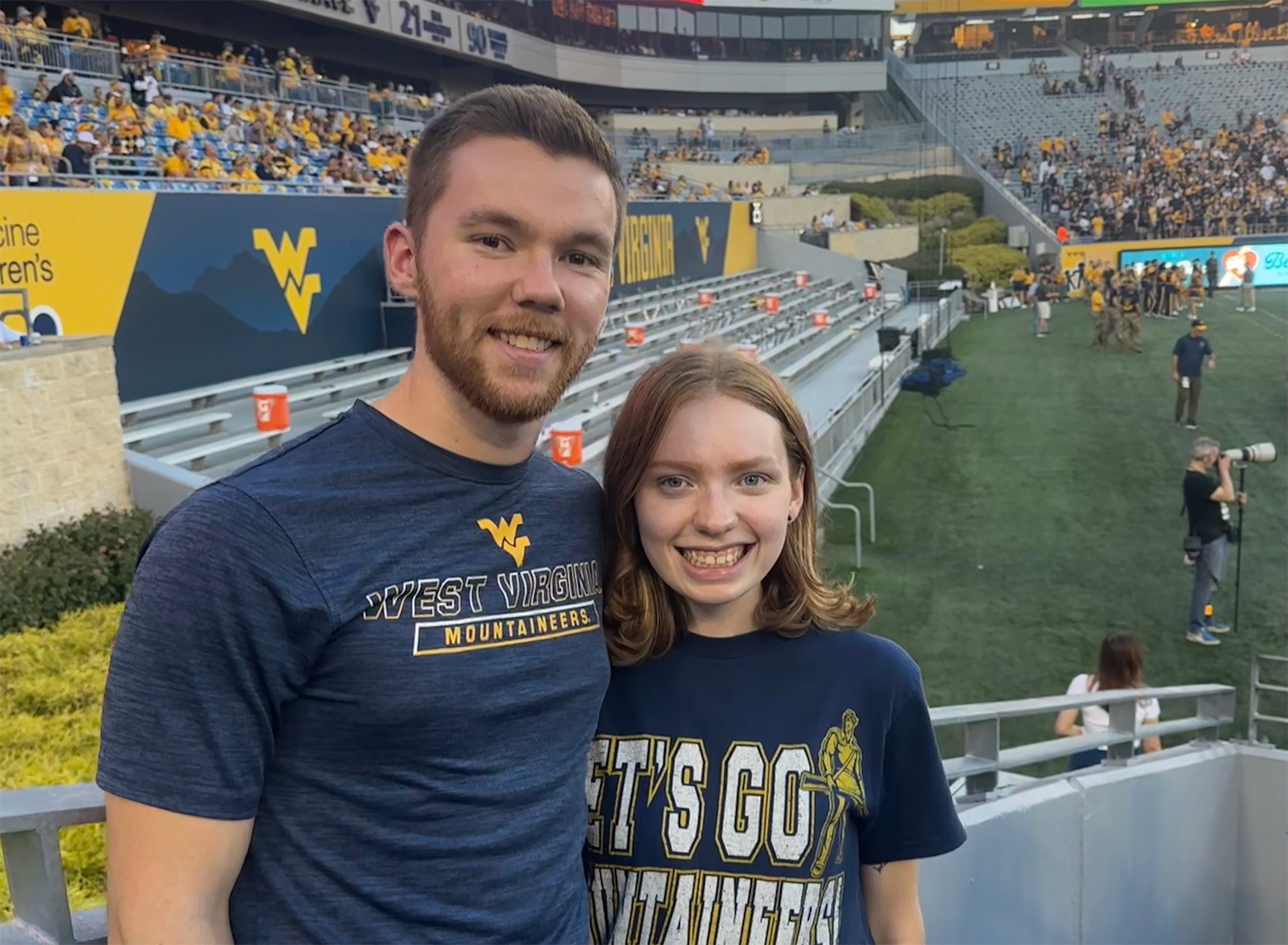 Photo of Kayla Brown and Parker Stout standing together at a WVU Football game.