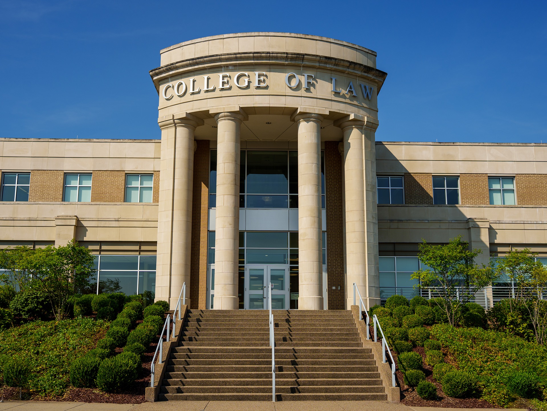 View of the large pillar front entrance of the WVU College of Law.