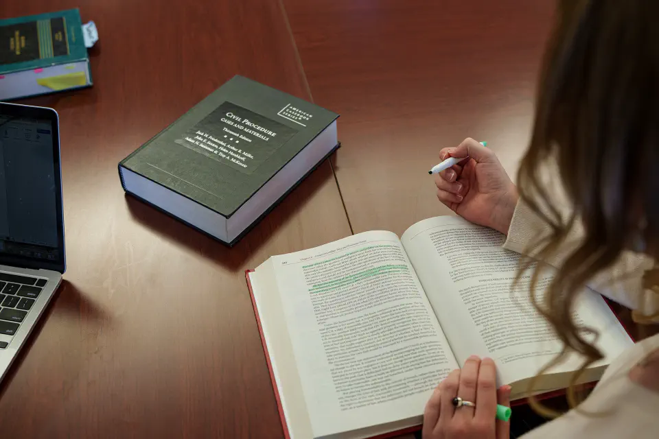A WVU law student highlights a sentence their law textbook.