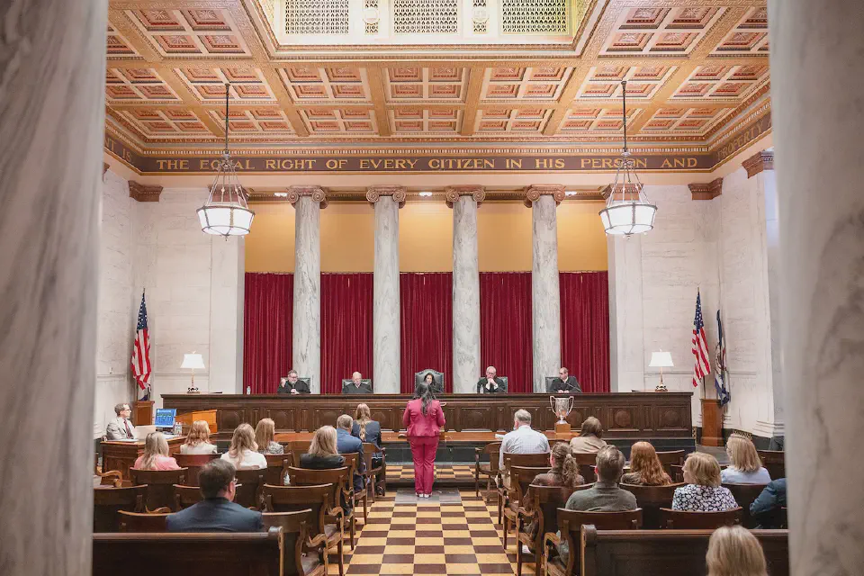 Photo of a WVU Law student standing at a podium in the WV Supreme Court.