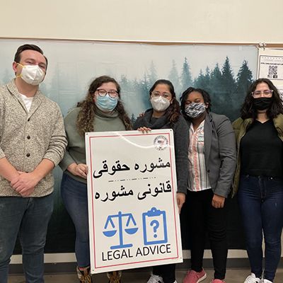 WVU Law - student members of the team that helped Afghans old a legal advice sign