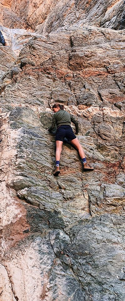 WVU Law student Madison Hinkle climbing a cliff face