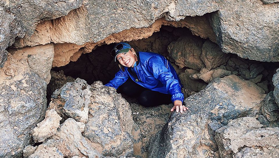 WVU Law student Madison Hinkle coming out of a cave